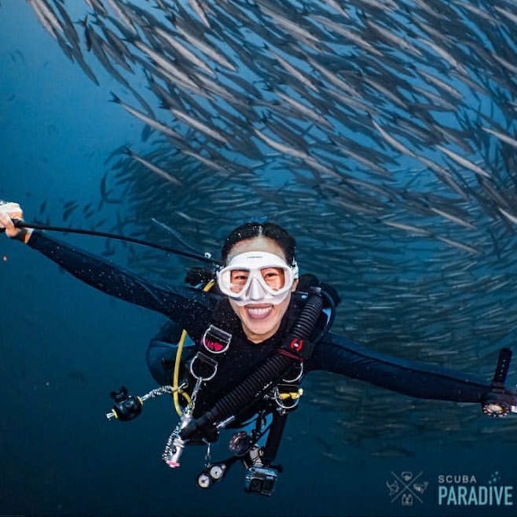Nina scuba diving with fish
